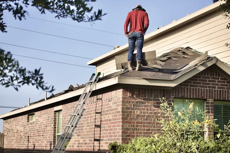 Professional roofer working on a residential roof in Wild Oaks